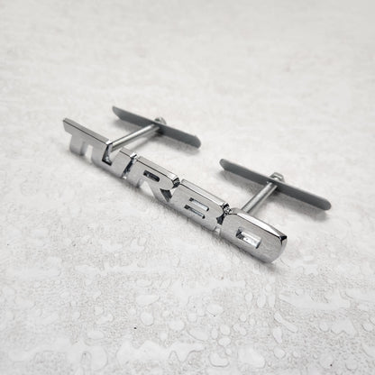 Turbo Silver Grille Metal Emblem (14.9 x 3.2 cm)